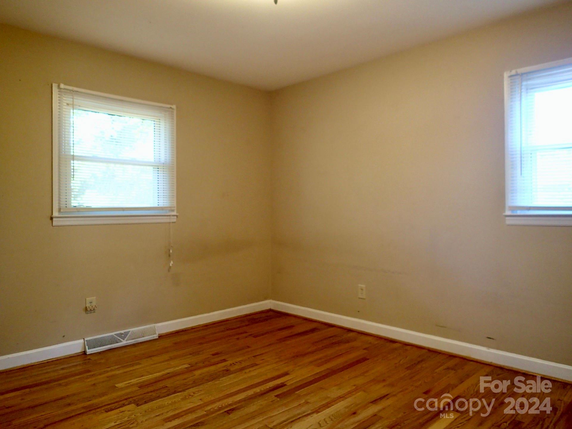 158 Crestview Street Rutherfordton, NC 28139 - Photo 20 of 34 a view of an empty room with wooden floor and a window