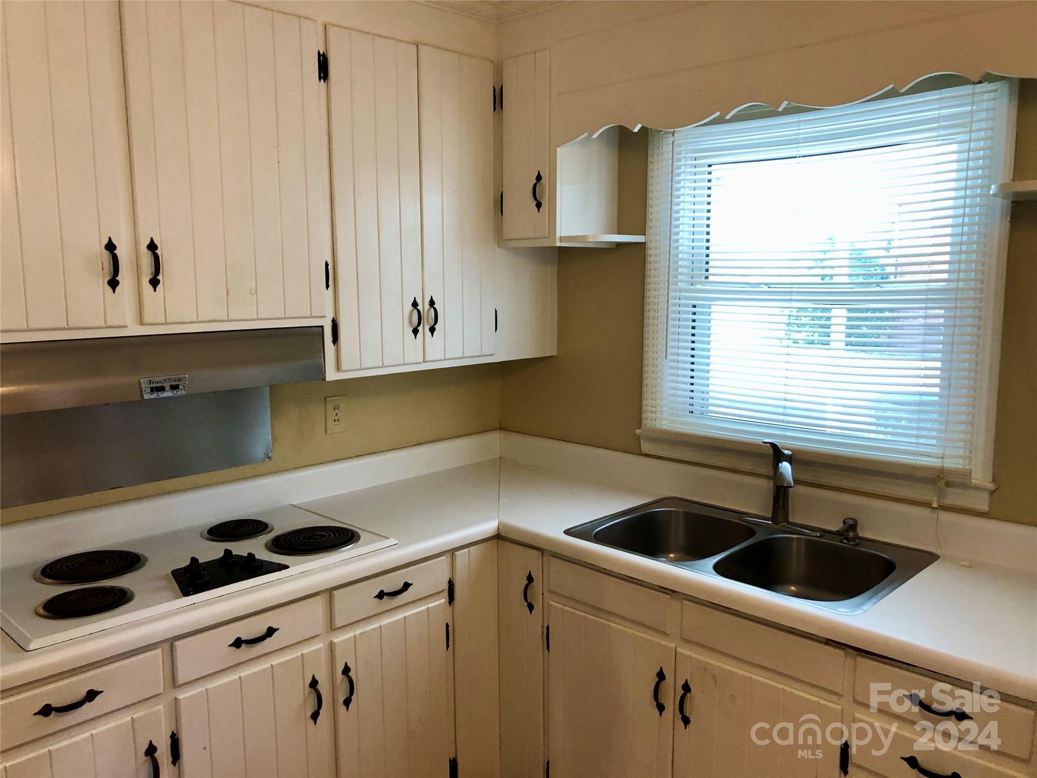 158 Crestview Street Rutherfordton, NC 28139 - Photo 5 of 34 a kitchen with a sink a window and cabinets