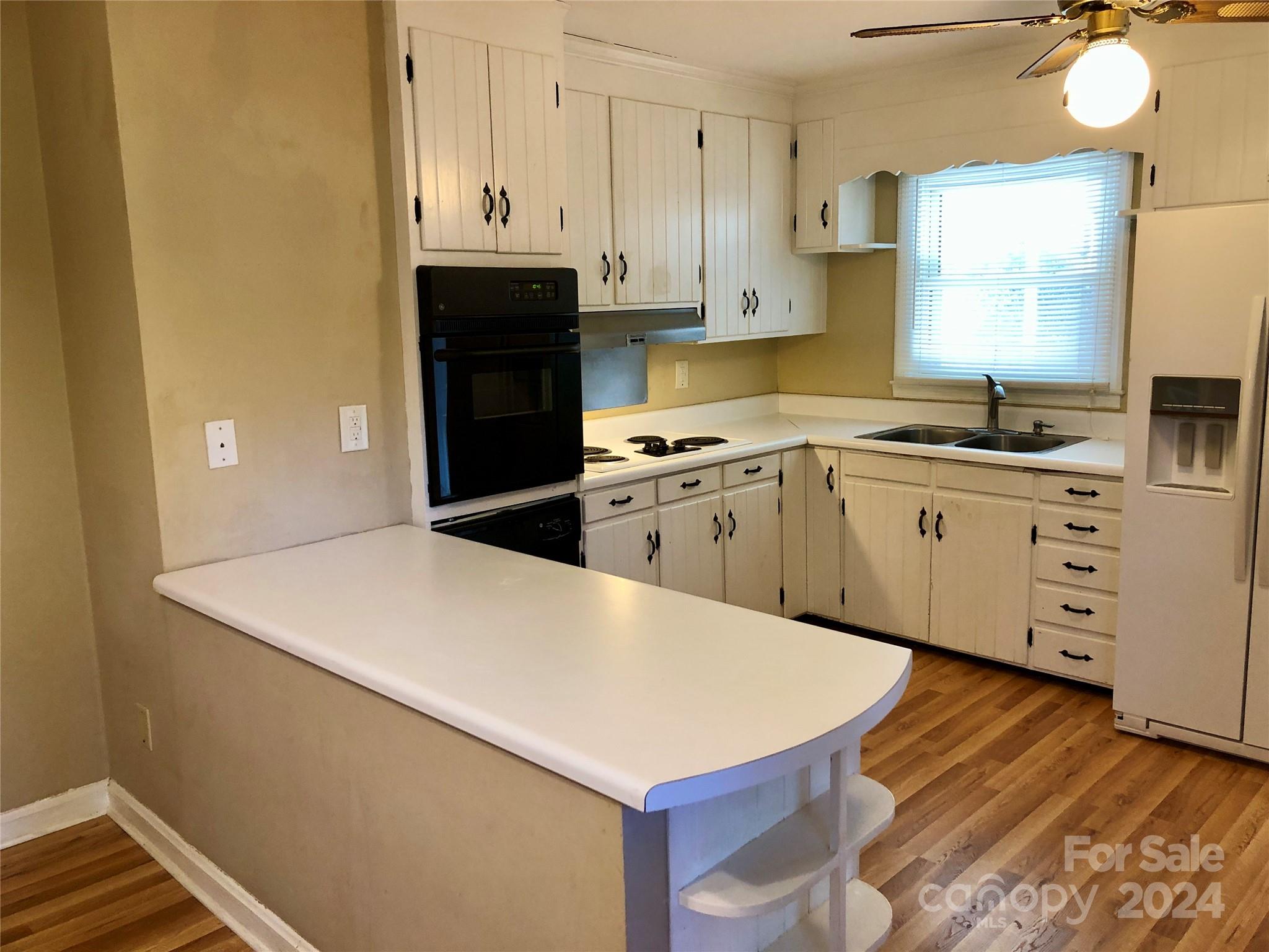 158 Crestview Street Rutherfordton, NC 28139 - Photo 8 of 34 a kitchen with a stove a sink and a refrigerator