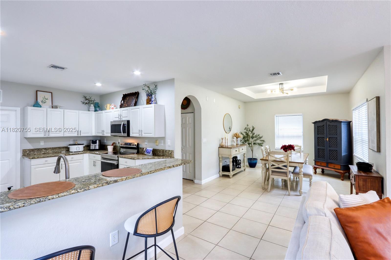 148 Northeast 36th Avenue Road Homestead, FL 33033 - Photo 23 of 53 a kitchen with stainless steel appliances granite countertop a refrigerator and a stove top oven