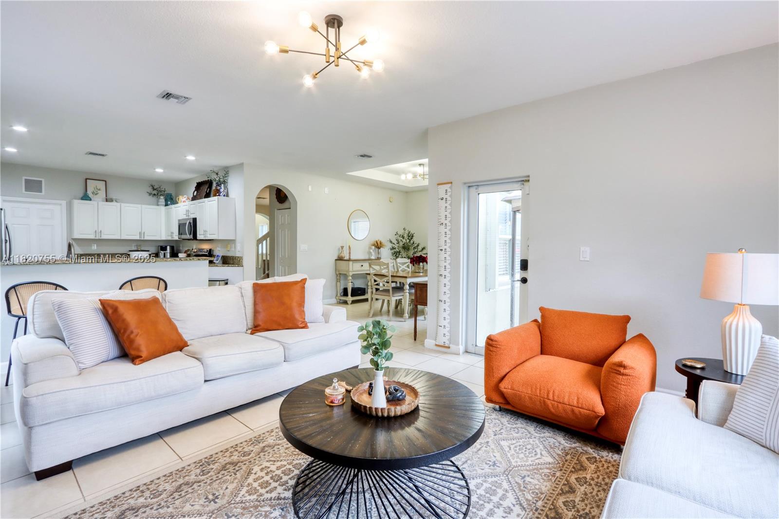 148 Northeast 36th Avenue Road Homestead, FL 33033 - Photo 25 of 53 a living room with furniture kitchen view and a fireplace