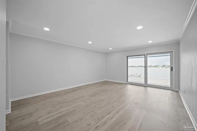 a spacious bedroom with a bed and a window