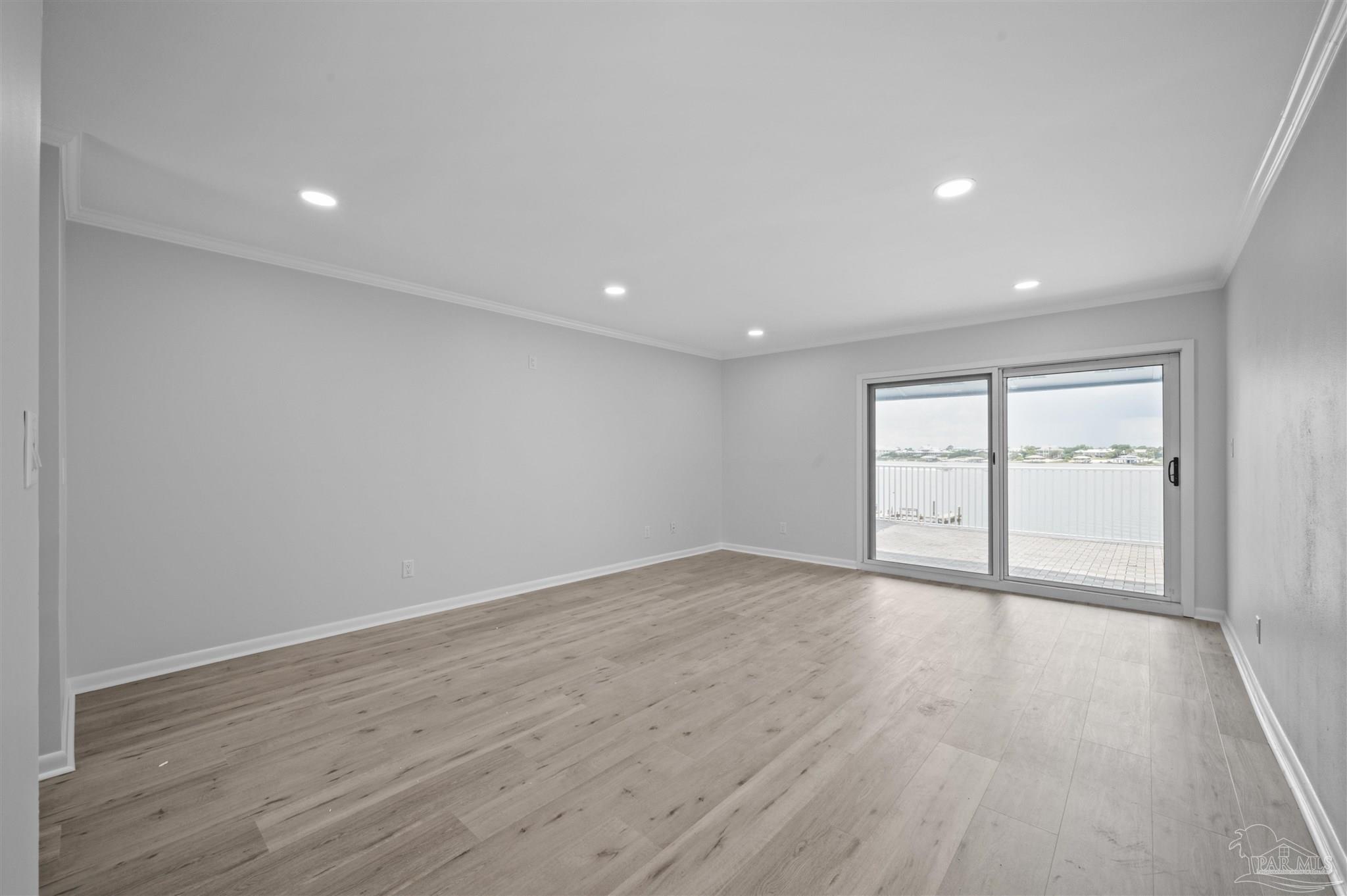 16470 Perdido Key Drive, Unit 33B Perdido Key, FL 32507 - Photo 12 of 32 an empty room with wooden floor and windows