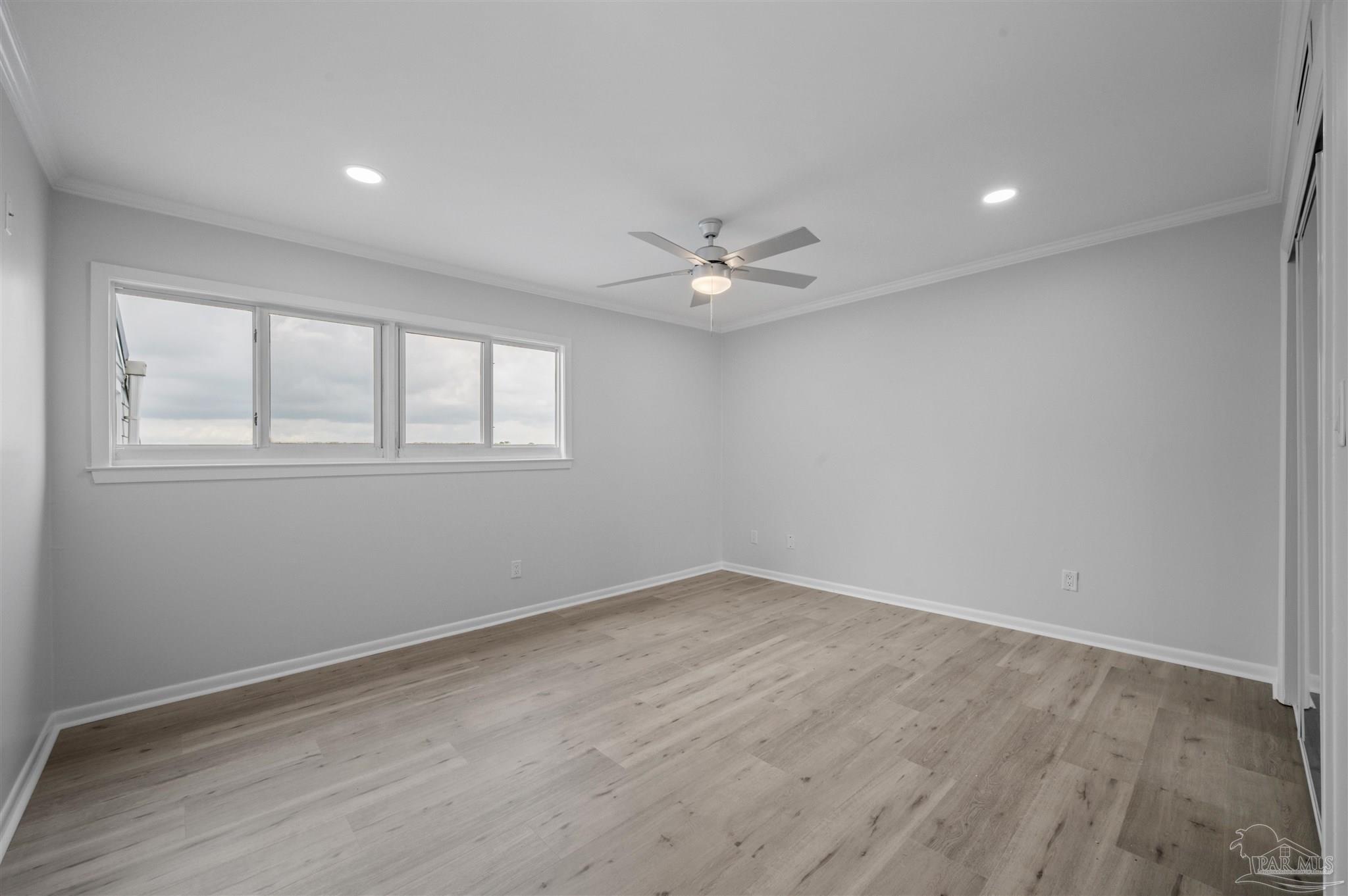 16470 Perdido Key Drive, Unit 33B Perdido Key, FL 32507 - Photo 13 of 32 wooden floor in an empty room with a window