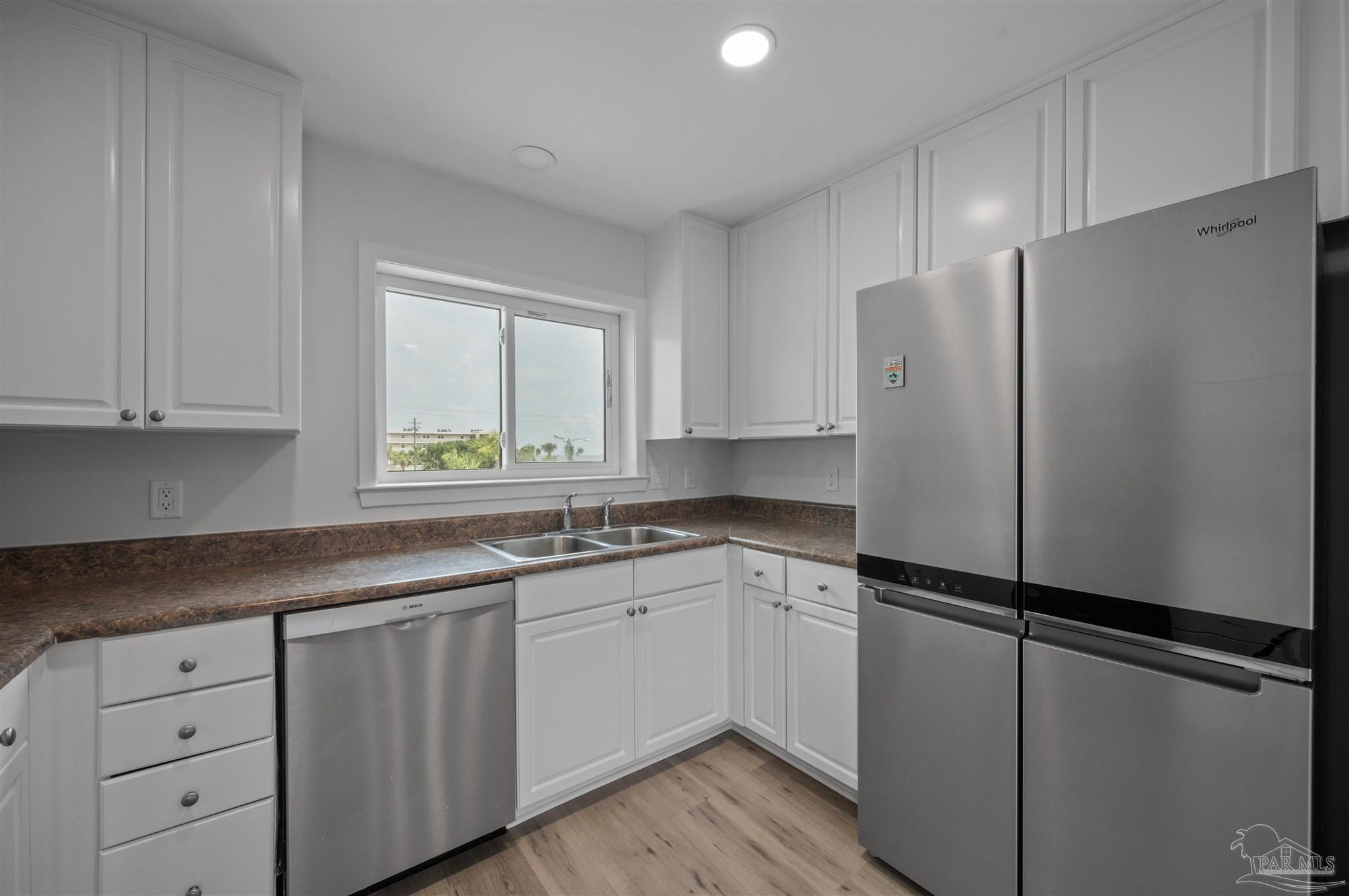 16470 Perdido Key Drive, Unit 33B Perdido Key, FL 32507 - Photo 3 of 32 a kitchen with a refrigerator sink and cabinets