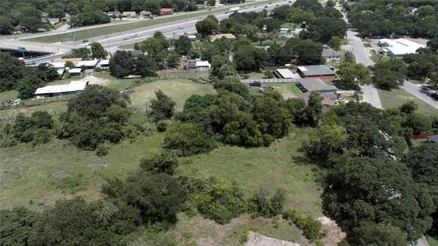 an aerial view of residential house with outdoor space and trees all around