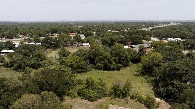 an aerial view of residential houses with city view