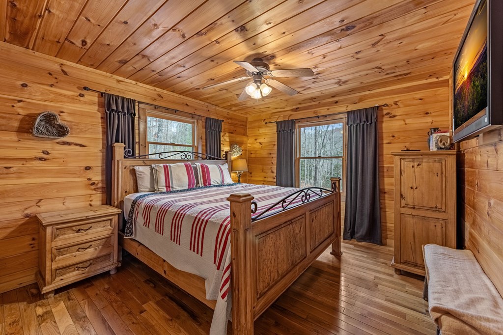 126 Sugar Mountain Road Blue Ridge, GA 30513 - Photo 13 of 78 a bedroom with a bed closet and flat tv screen