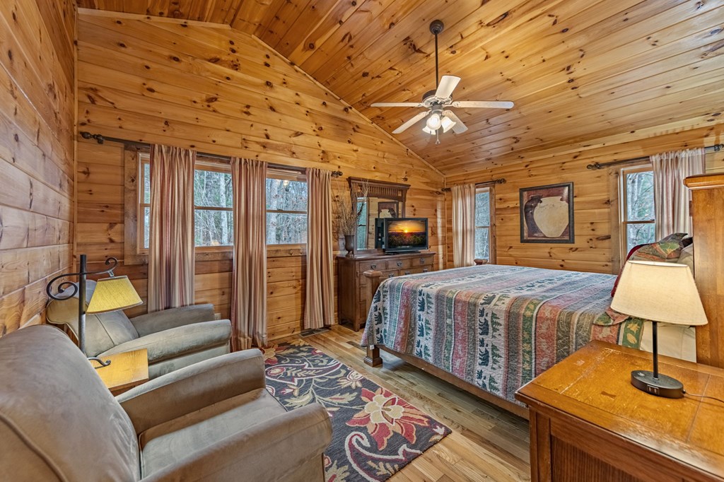 126 Sugar Mountain Road Blue Ridge, GA 30513 - Photo 18 of 78 a spacious bedroom with a bed a couch and dresser