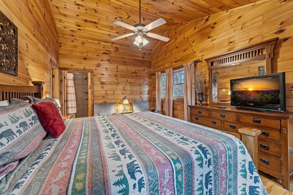 126 Sugar Mountain Road Blue Ridge, GA 30513 - Photo 19 of 78 a bedroom with a bed and a flat screen tv