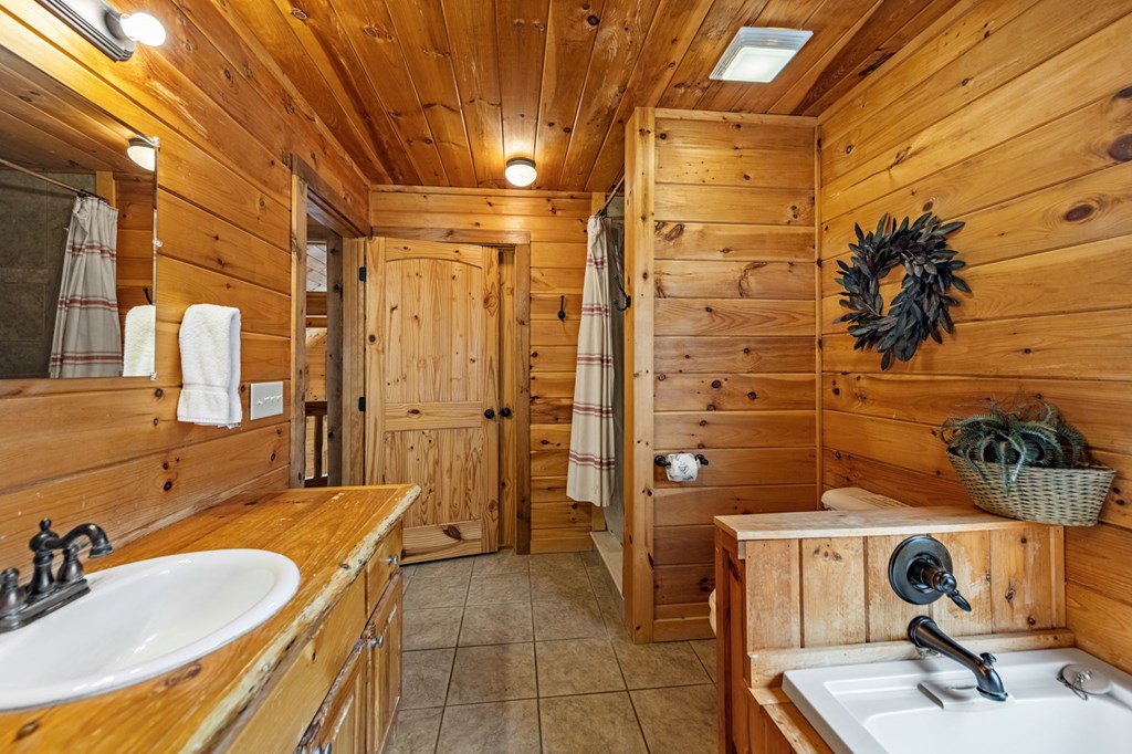 126 Sugar Mountain Road Blue Ridge, GA 30513 - Photo 21 of 78 a bathroom with a sink and mirror
