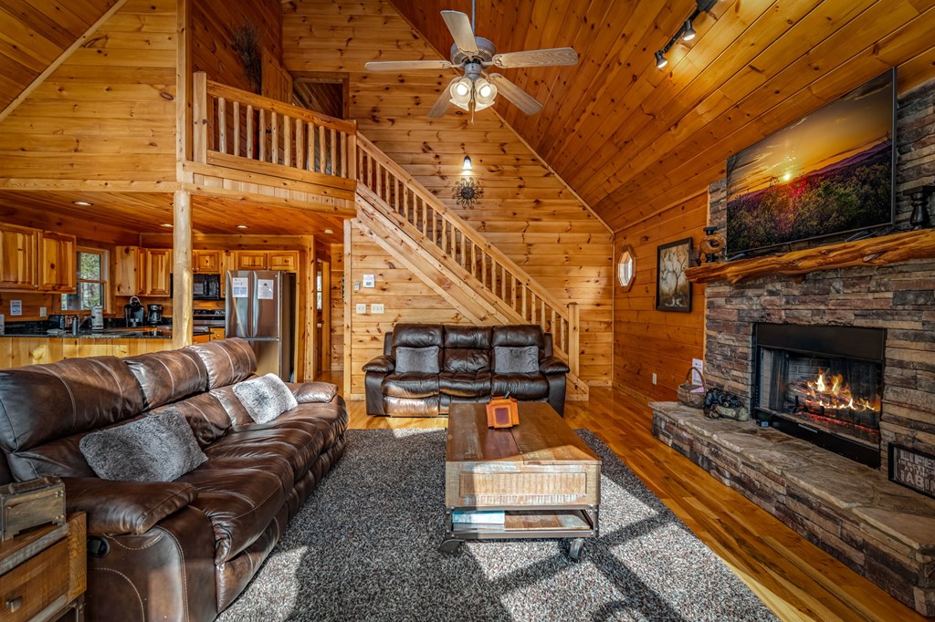 126 Sugar Mountain Road Blue Ridge, GA 30513 - Photo 58 of 78 a living room with furniture a fireplace and a table