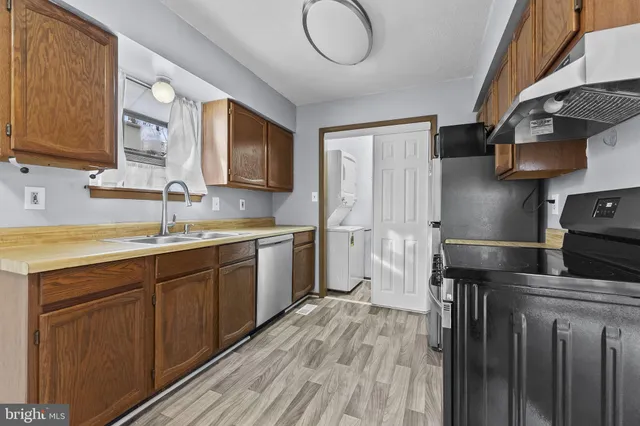 a kitchen with a sink cabinets and stainless steel appliances