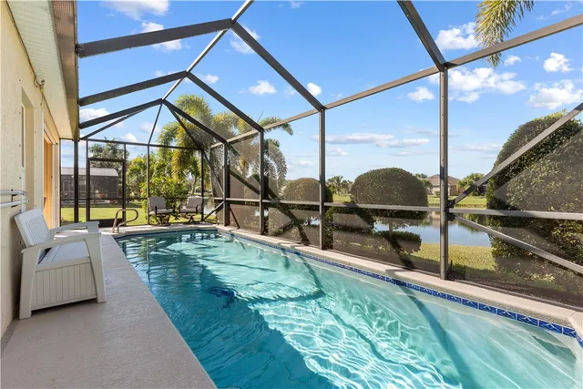 an aerial view of residential houses with outdoor space and swimming pool