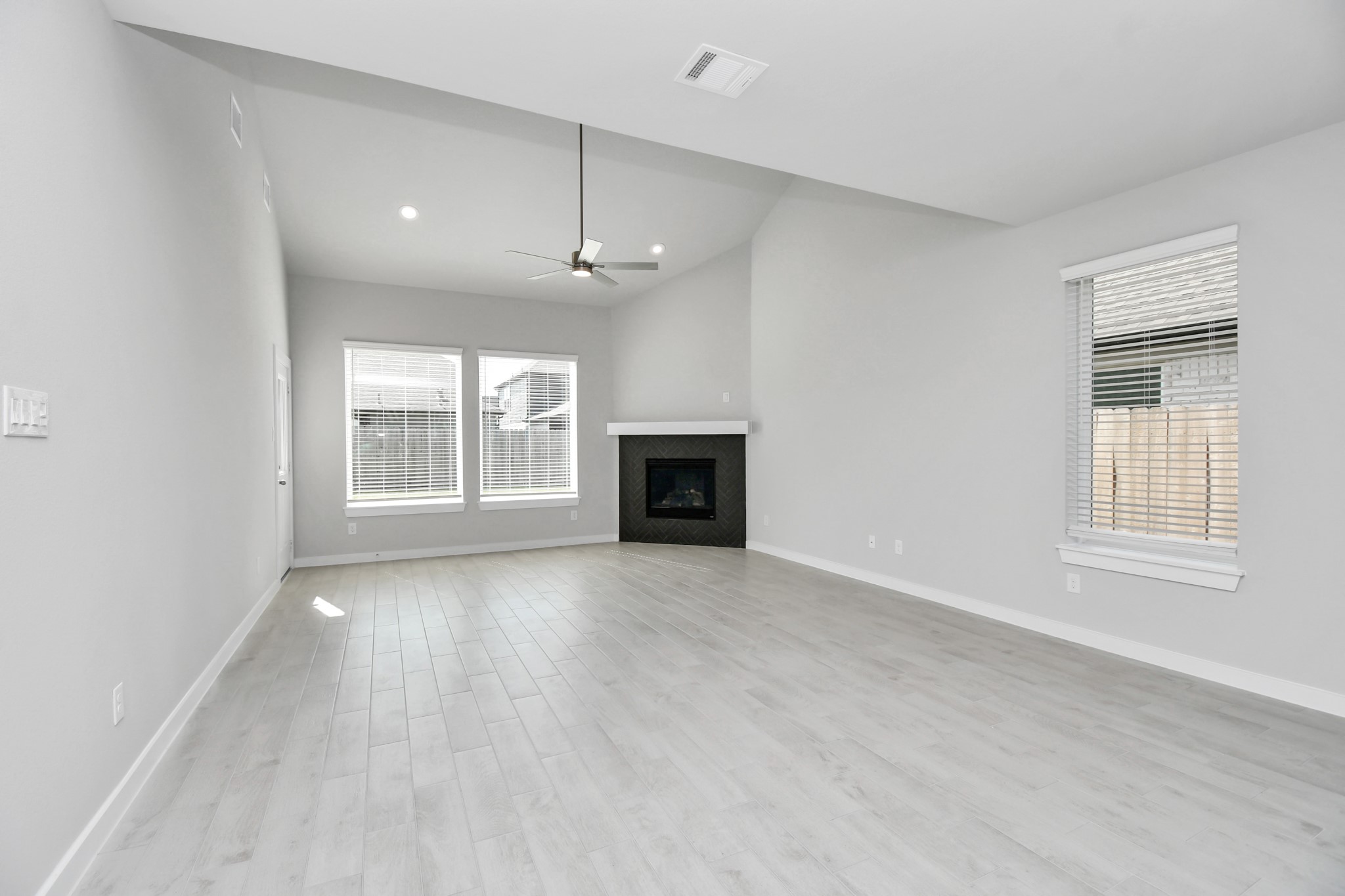 14606 Surfbird Lane Houston, TX 77049 - Photo 16 of 45 Welcome family and guests to your charming living room! With its high ceilings, recessed lighting, ceiling fan, custom paint, beautiful flooring, and large windows that let in abundant natural light, this room is perfect for gatherings.