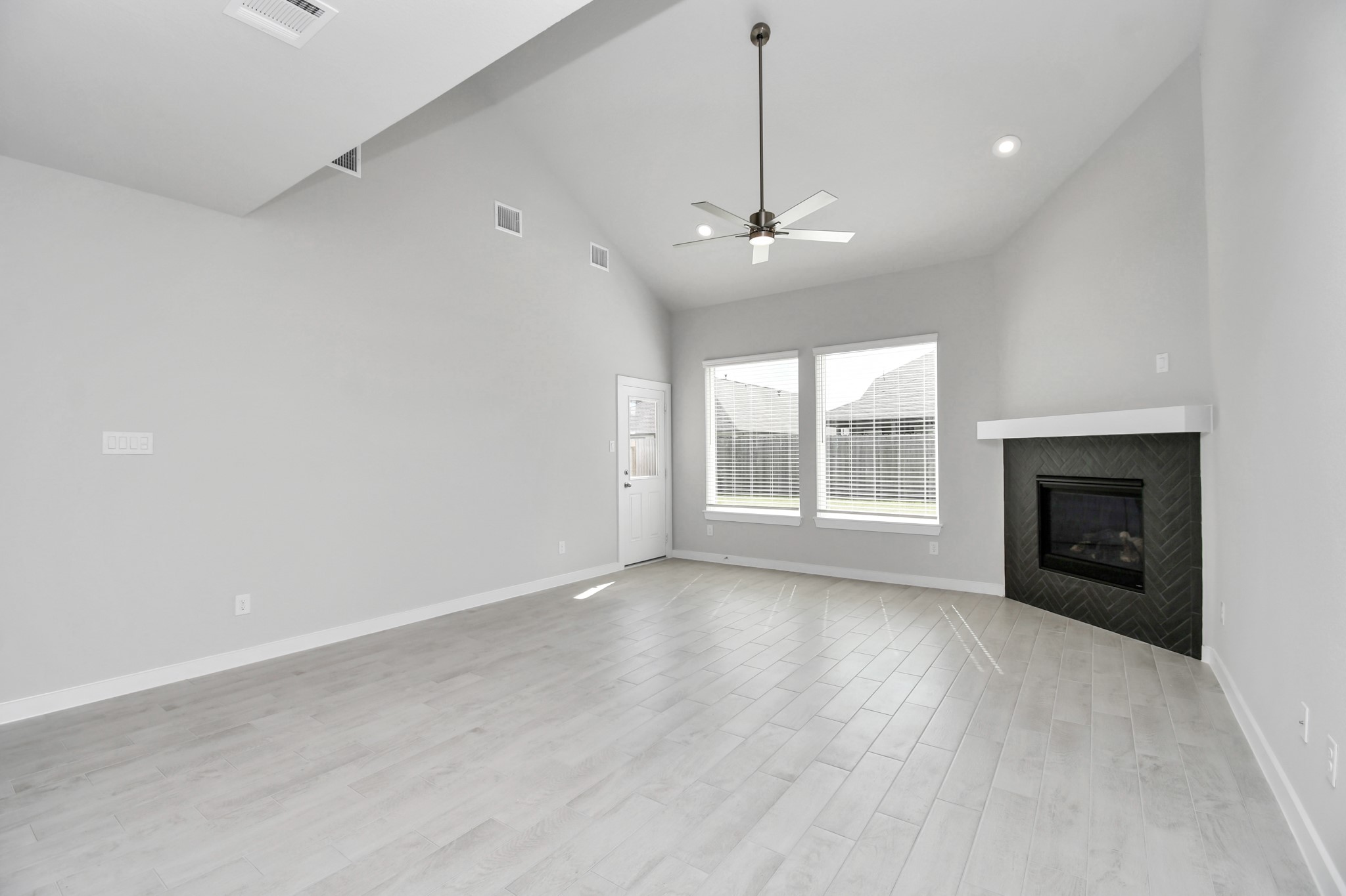 14606 Surfbird Lane Houston, TX 77049 - Photo 17 of 45 Gather the family and guests together in your lovely living room! Featuring soaring high ceilings, recessed lighting, ceiling fan, custom paint, gorgeous floors, and large windows that provide plenty of natural lighting throughout the day.
