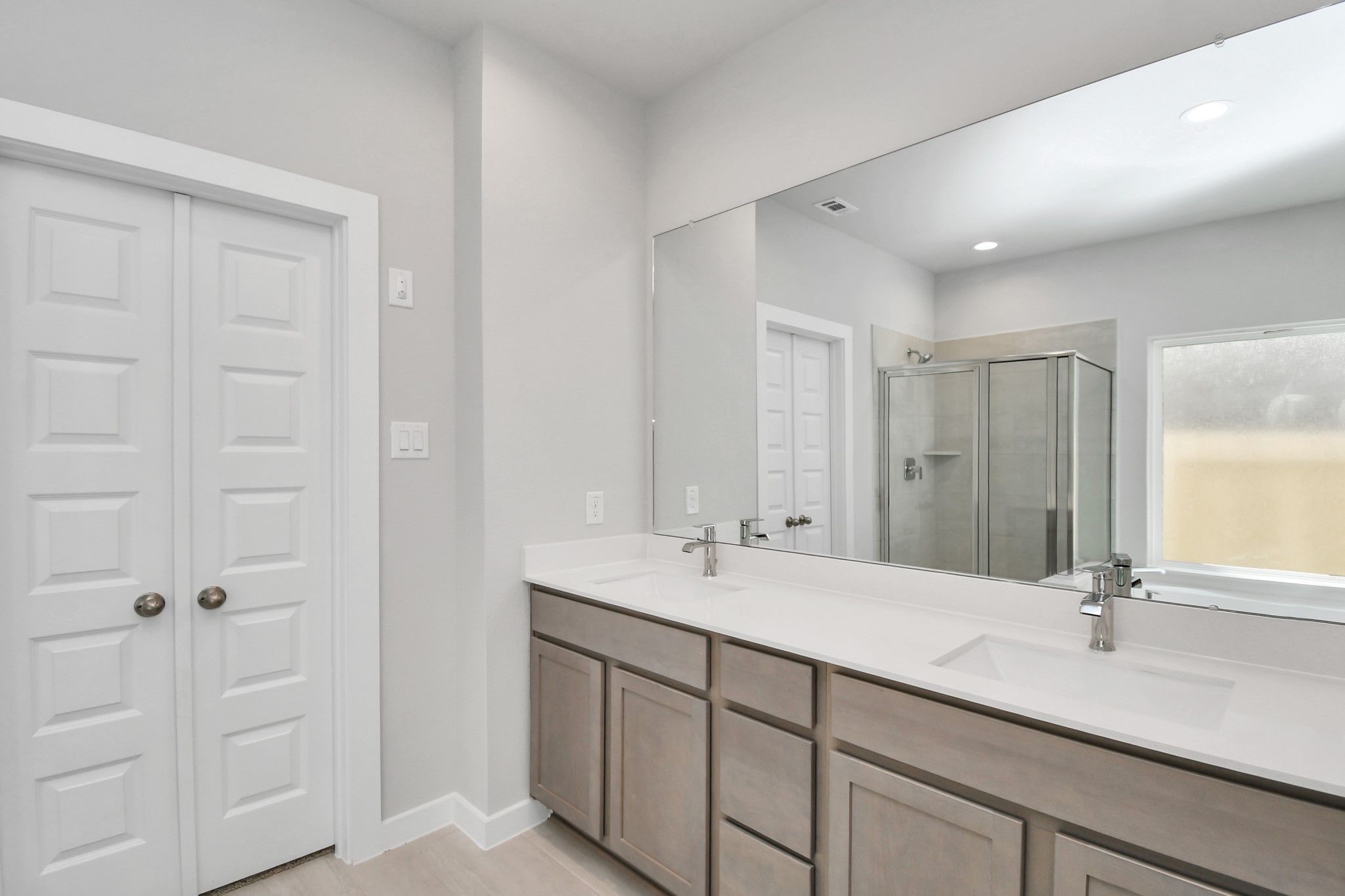 14606 Surfbird Lane Houston, TX 77049 - Photo 25 of 45 Elevate your daily routine at the elegant vanity, now equipped with double sinks, light countertops, modern hardware, and beautiful recessed lights.