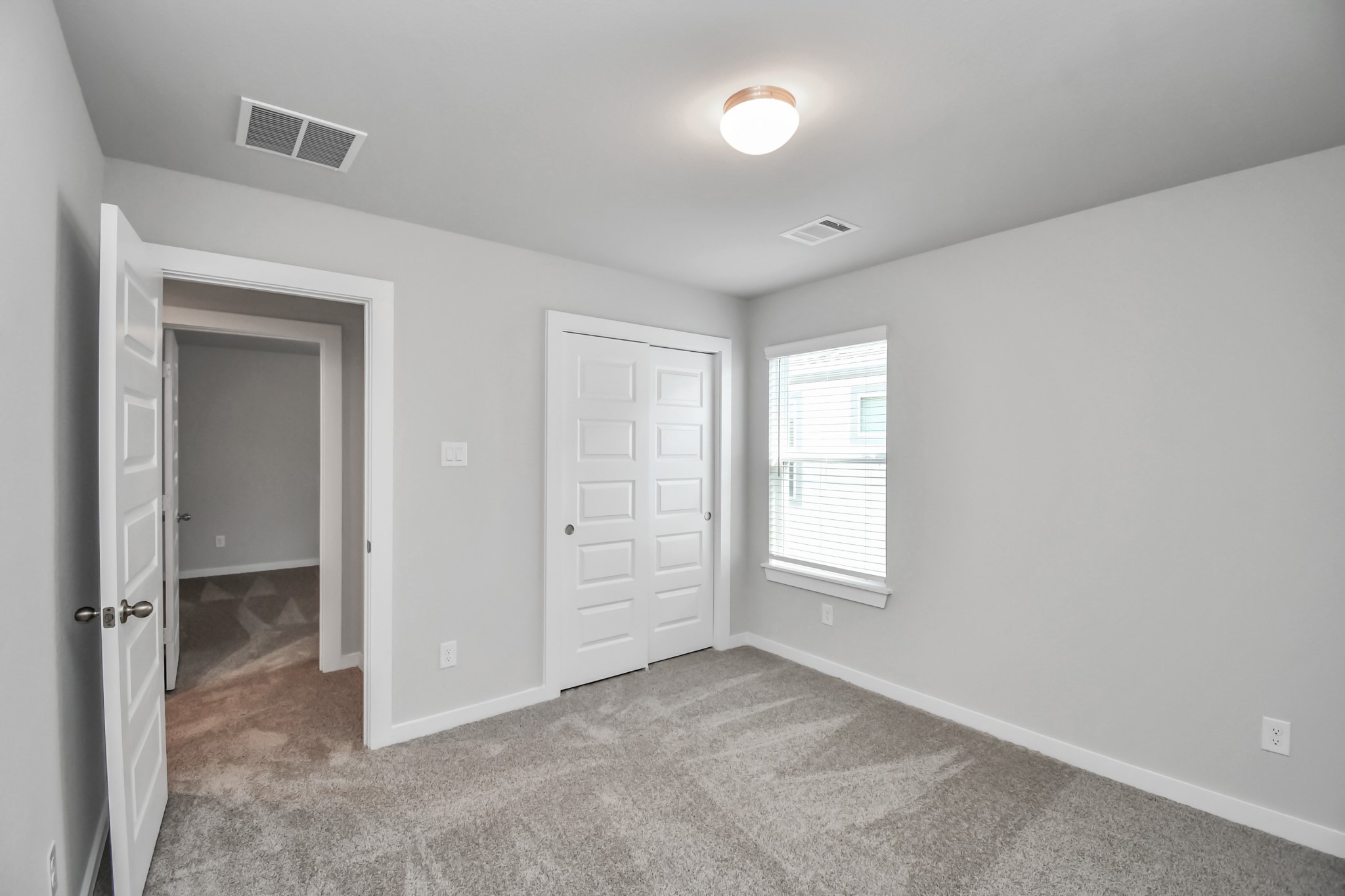 14606 Surfbird Lane Houston, TX 77049 - Photo 30 of 45 Generously sized secondary bedrooms featuring spacious closets, soft and inviting carpeting underfoot, large windows allowing plenty of natural light, and the added touch of privacy blinds for your personal retreat.