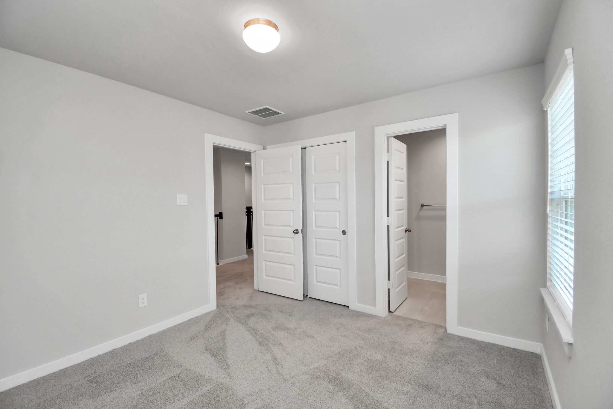 14606 Surfbird Lane Houston, TX 77049 - Photo 33 of 45 Generously sized secondary bedrooms featuring spacious closets, soft and inviting carpeting underfoot, large windows allowing plenty of natural light, and the added touch of privacy blinds for your personal retreat.