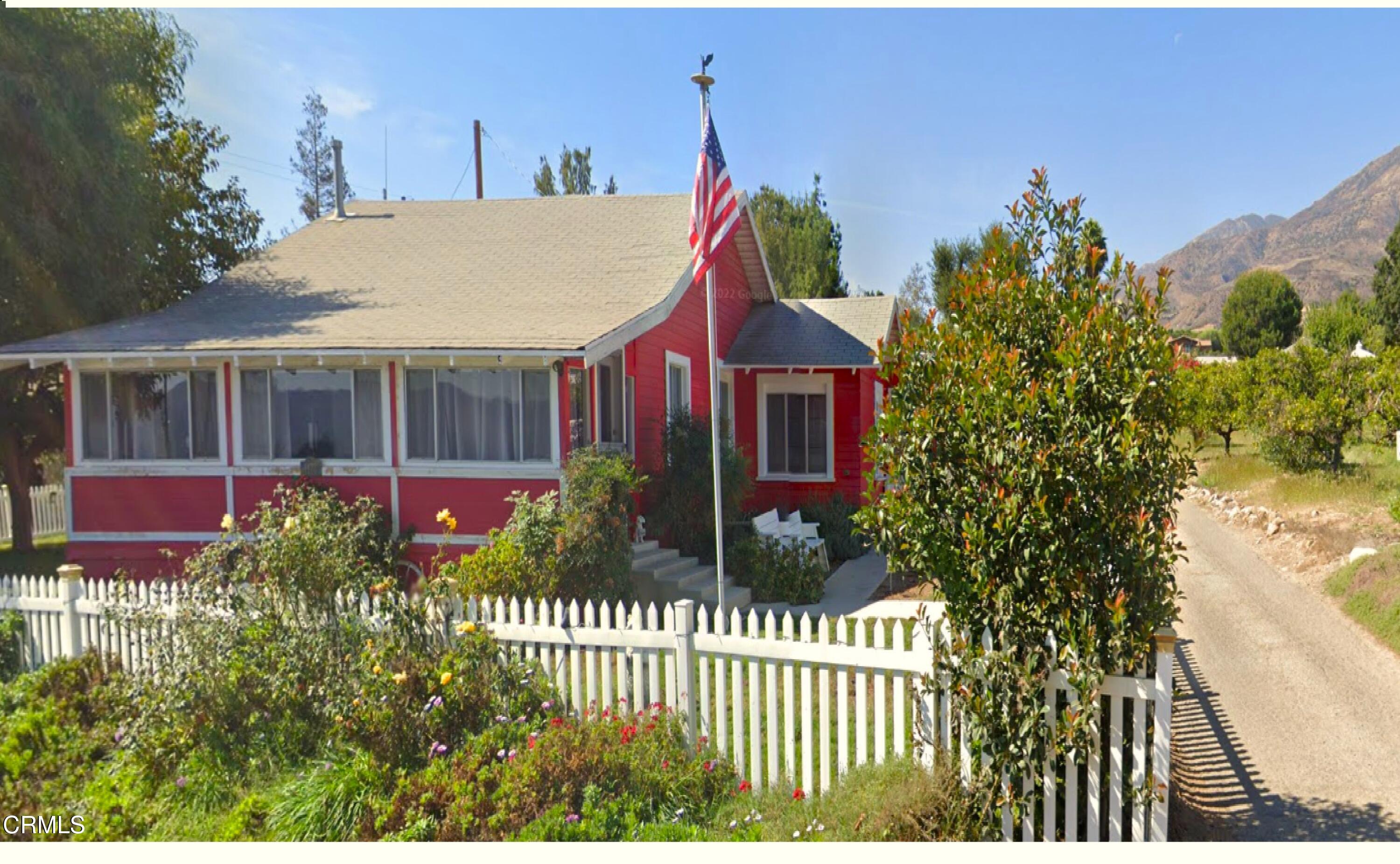 a view of a house with a small yard and a garden