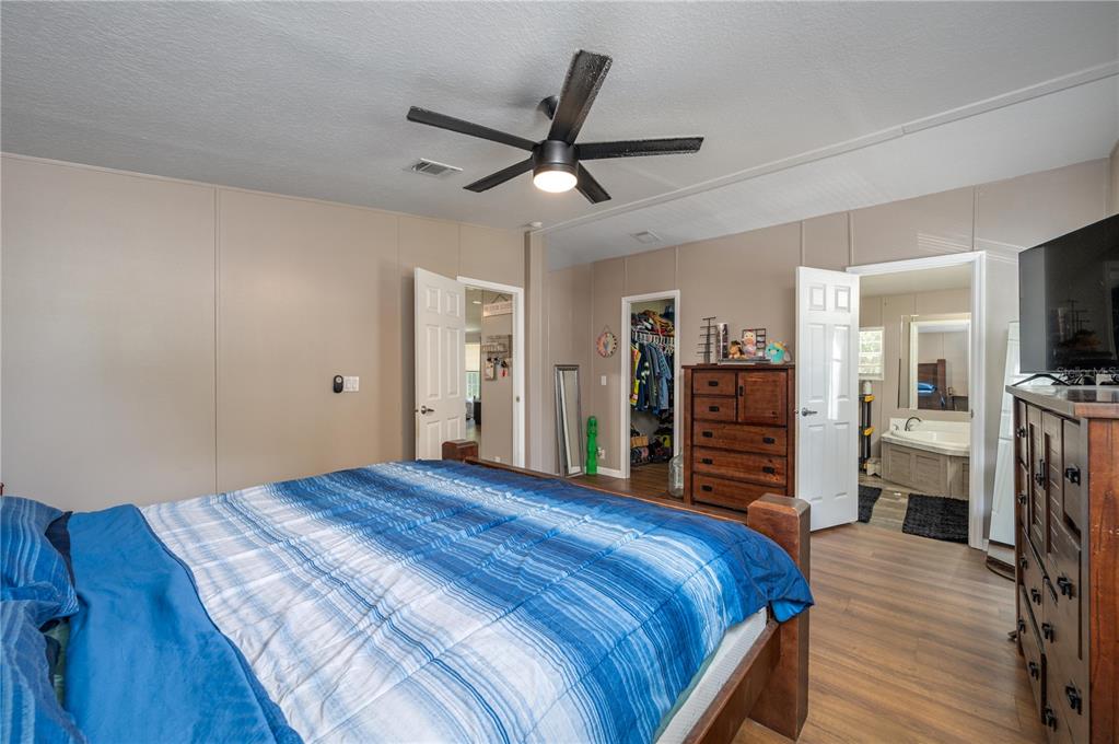 15079 Brahma Road Polk City, FL 33868 - Photo 7 of 40 a bed room with a bed and a television