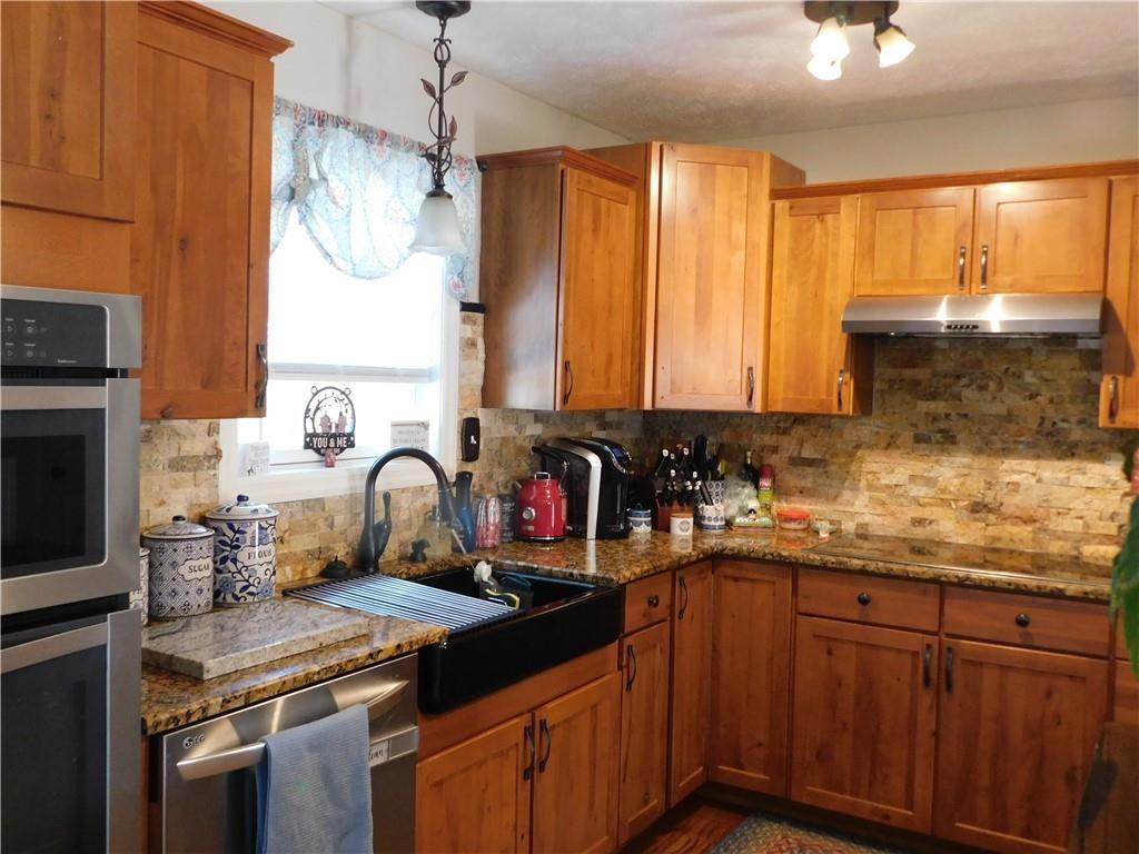 309 Shagbark Road Grindstone, PA 15442 - Photo 14 of 45 a kitchen with granite countertop a sink stove and cabinets