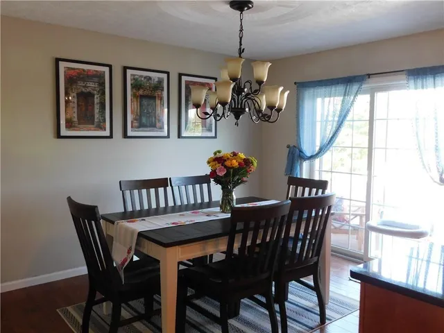 a dining room with furniture a livingroom and chandelier
