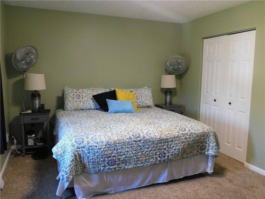 309 Shagbark Road Grindstone, PA 15442 - Photo 19 of 45 a bedroom with a bed and wooden floor