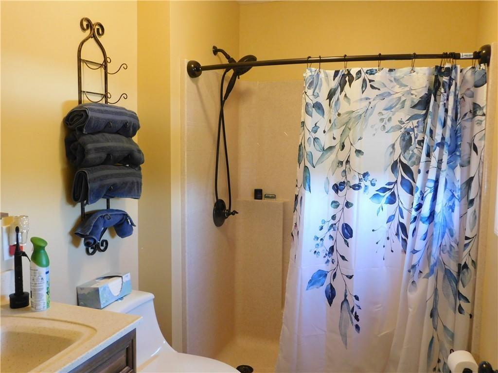 309 Shagbark Road Grindstone, PA 15442 - Photo 22 of 45 a bathroom with a shower curtain and a sink