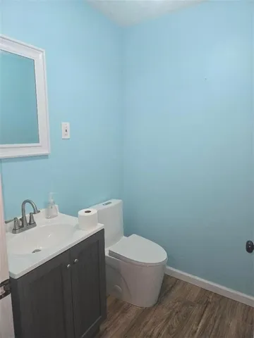 a bathroom with a toilet a sink and mirror