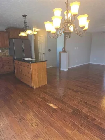 a view of a bathroom with a sink a mirror and a chandelier