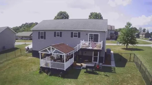 a aerial view of a house with a yard balcony and furniture