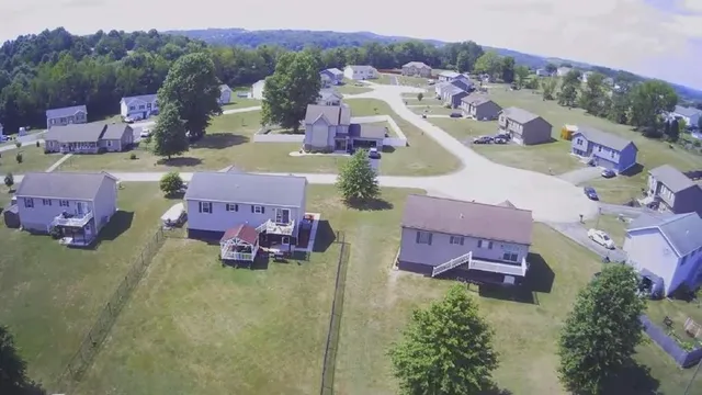 an aerial view of a houses with a swimming pool