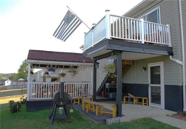 a view of a house with a yard and deck