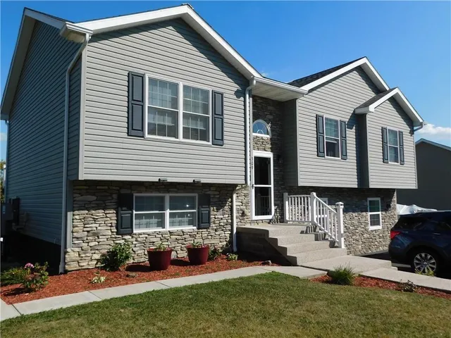 a front view of a house with a yard tv and outdoor seating