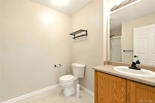 a bathroom with a sink a toilet and mirror
