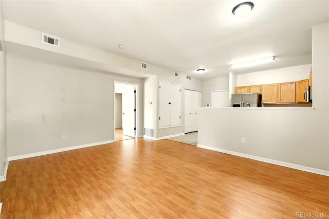 a view of an empty room with wooden floor