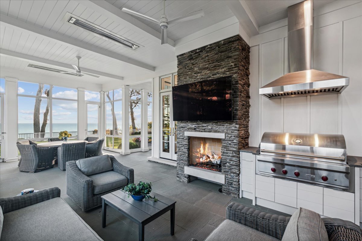 973 Sheridan Road Winnetka, IL 60093 - Photo 30 of 92 a living room with furniture a flat screen tv and a fireplace