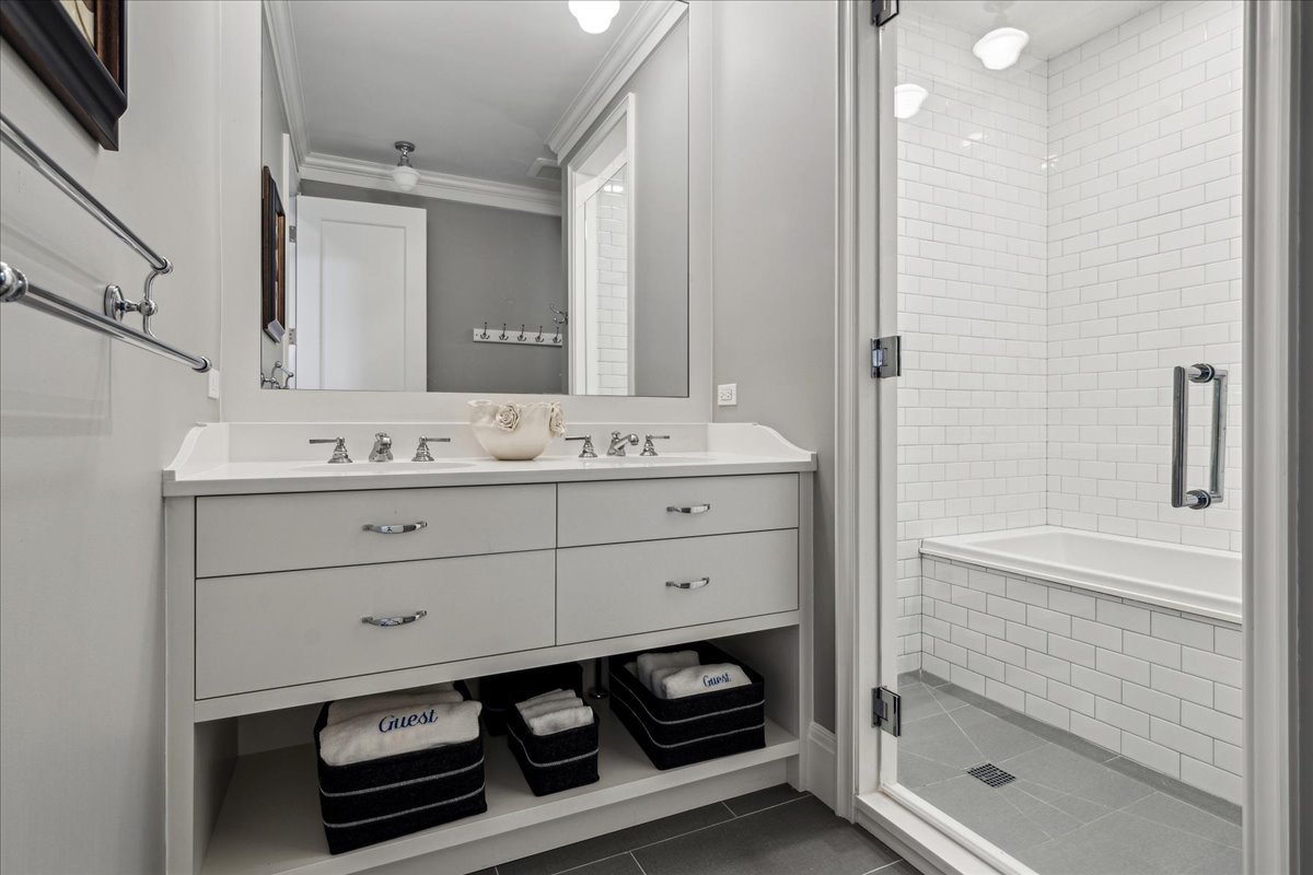 973 Sheridan Road Winnetka, IL 60093 - Photo 74 of 92 a bathroom with a sink a vanity a mirror and a bathtub