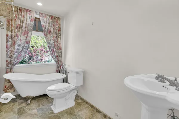 a white toilet sitting next to a bathroom sink