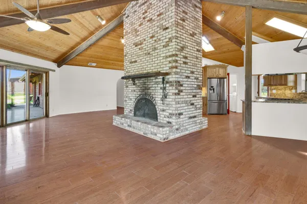 a view of an empty room with a fireplace