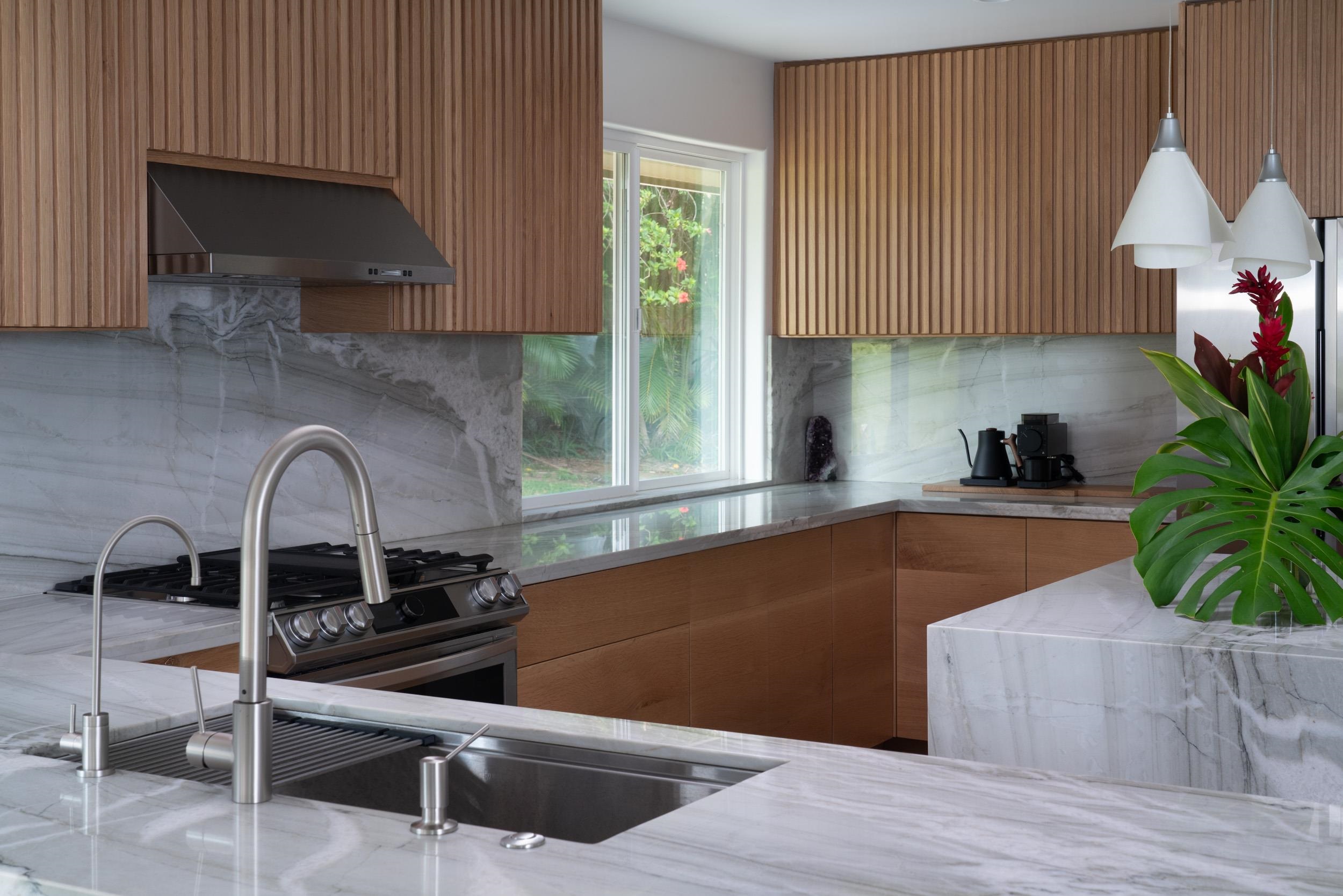 453 North Honokala Road Haiku, HI 96708 - Photo 9 of 33 a kitchen with granite countertop a stove a sink and a microwave