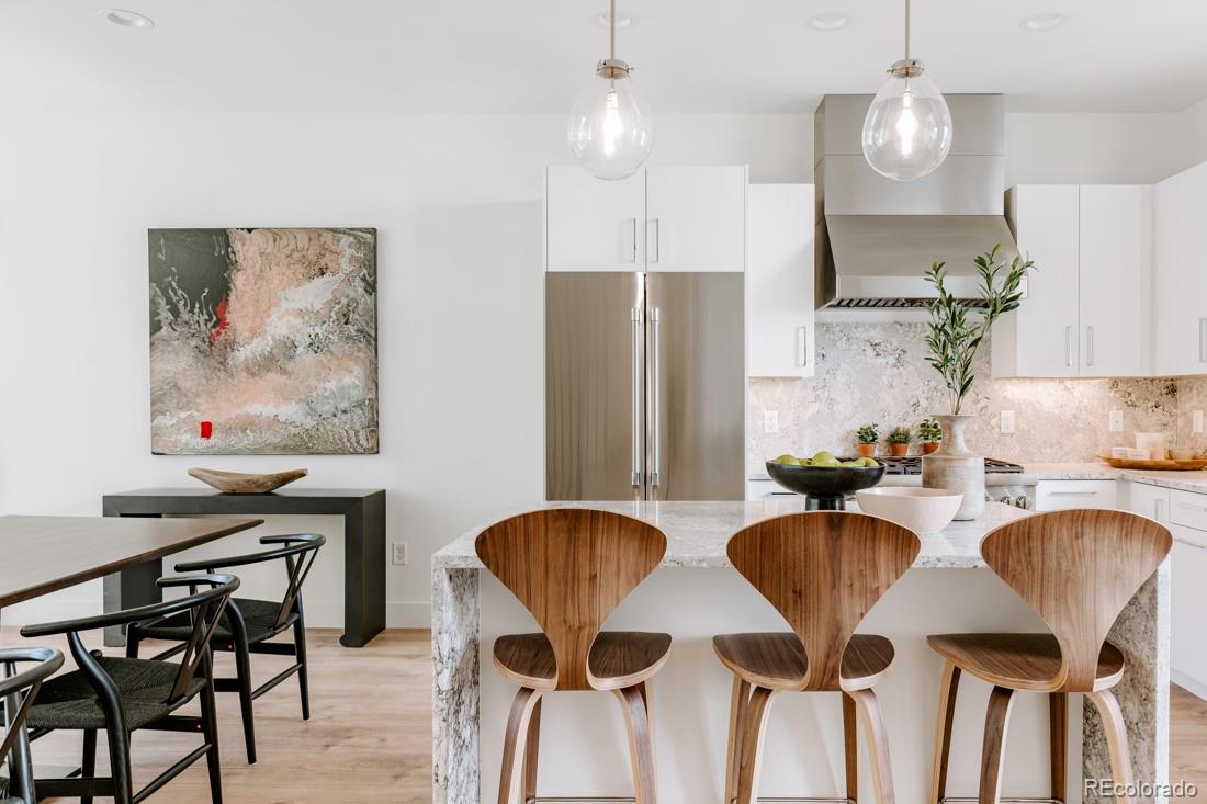 838 Ash Street, Unit 6 Denver, CO 80220 - Photo 14 of 40 a kitchen with stainless steel appliances granite countertop a dining table chairs and a refrigerator