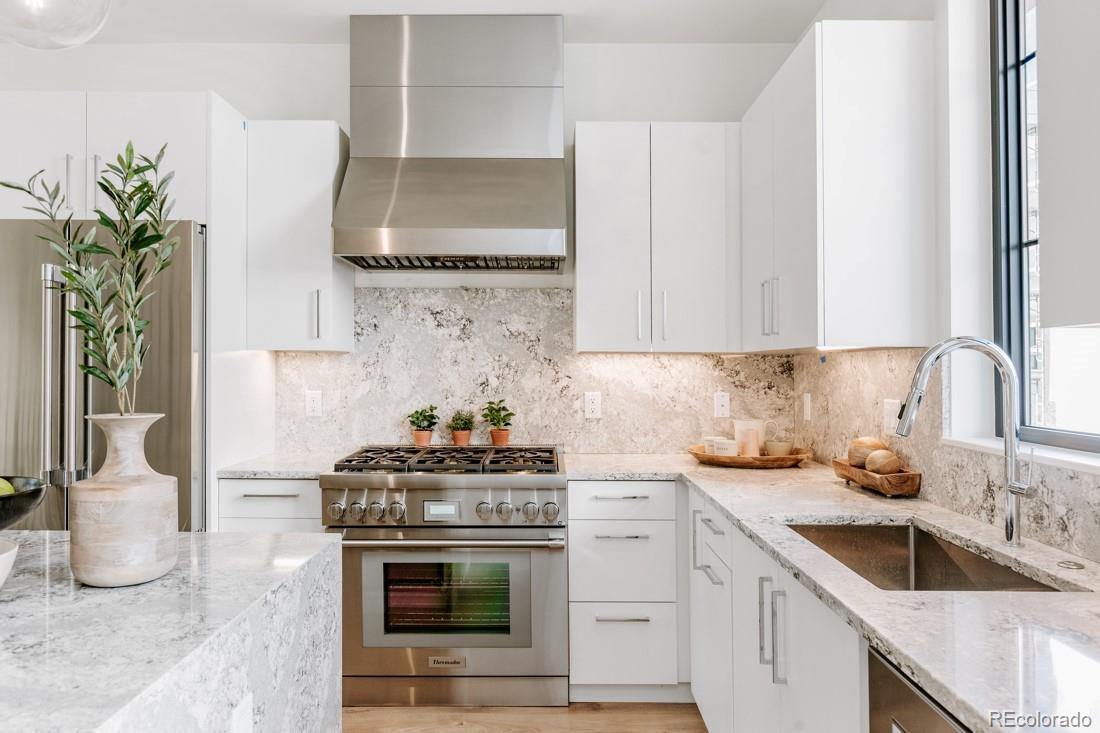 838 Ash Street, Unit 6 Denver, CO 80220 - Photo 15 of 40 a kitchen with granite countertop a sink stove and cabinets