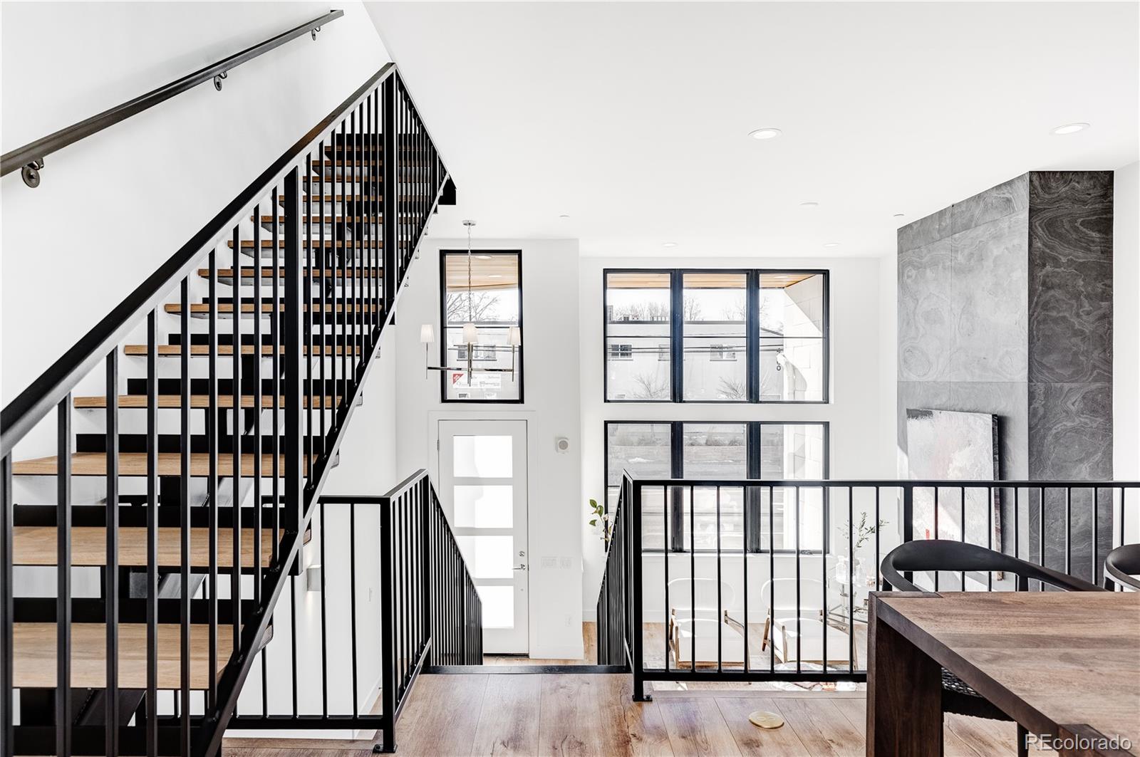 838 Ash Street, Unit 6 Denver, CO 80220 - Photo 28 of 40 a view of staircase with lots of wooden floor and windows