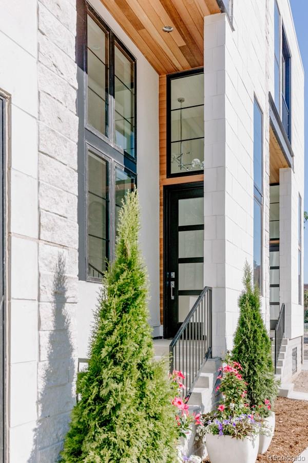 838 Ash Street, Unit 6 Denver, CO 80220 - Photo 35 of 40 a front view of a house with a garden