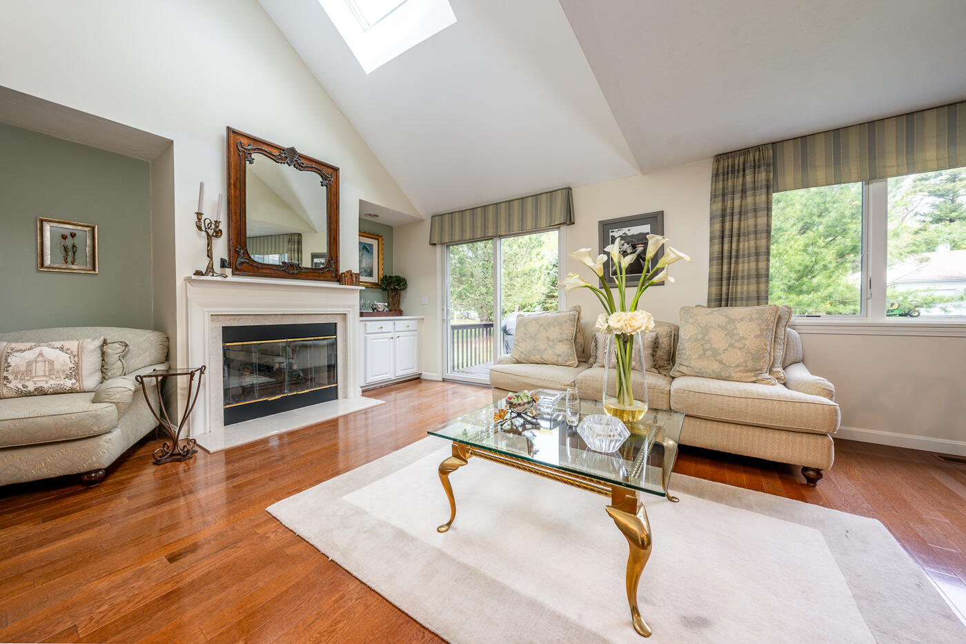 5 Classic Circle Mashpee, MA 02649 - Photo 4 of 18 a living room with furniture a fireplace and a large window