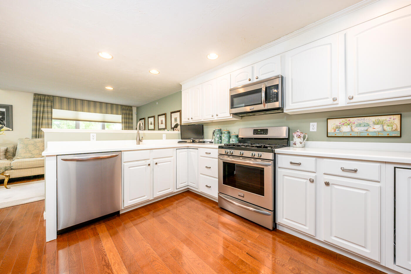 5 Classic Circle Mashpee, MA 02649 - Photo 6 of 18 a kitchen with stainless steel appliances granite countertop a stove top oven a sink dishwasher and white cabinets with wooden floor