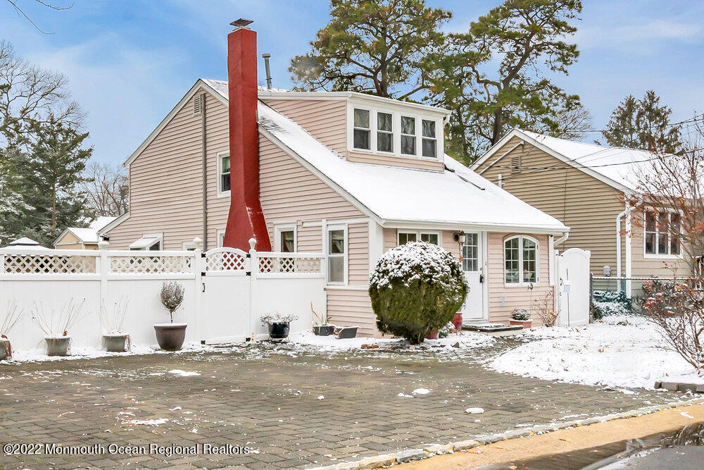 51 Dock Road Brick, NJ 08723 - Photo 4 of 57 a view of a white house with a potted plant and a table and chair