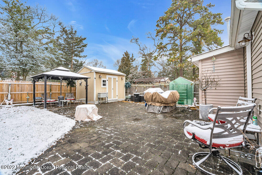 51 Dock Road Brick, NJ 08723 - Photo 50 of 57 a view of a patio with table and chairs and potted plants